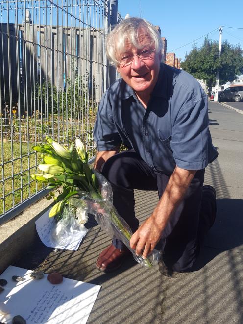 Peter Belton lays flowers outside the Dunedin mosque. Photo: David Loughrey