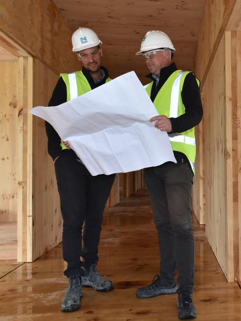 Naylor Love project manager Cameron Orr (left)  and operations manager Jason Tutty look at plans the west wing of the Otago Polytechnic’s  $20 million student village project. PHOTO: GREGOR RICHARDSON