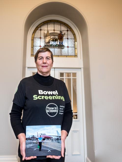 Rachel Elder, a strong advocate of bowel screening, holds a photo of her late brother, Hugh.
