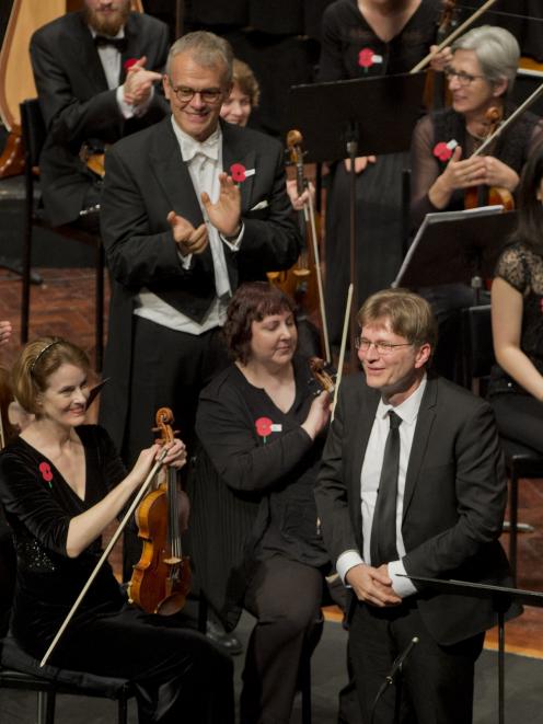 Simon Over (top left) and the Dunedin Symphony Orchestra applaud Dunedin composer Anthony Ritchie...
