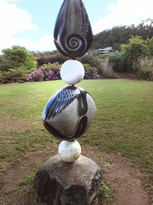 One of the numerous sculptures in the garden. The visitor centre is at the top right.