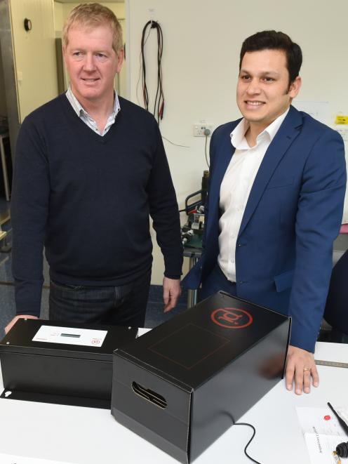 Photonic Innovations' executive chairman Steve Silvey, left and chief executive Ojas Mahapatra with an ammonia detection device, readying for delivery. Photos: Gregor Richardson