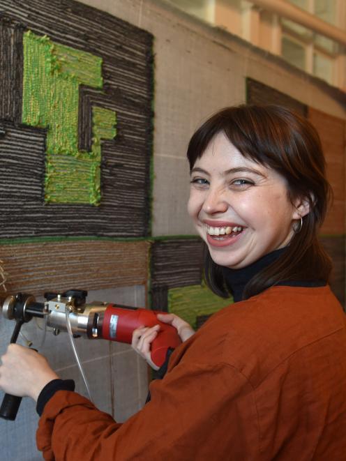 Megan Brady fits her carpet at Dunedin Public Art Gallery. Photos: Peter McIntosh