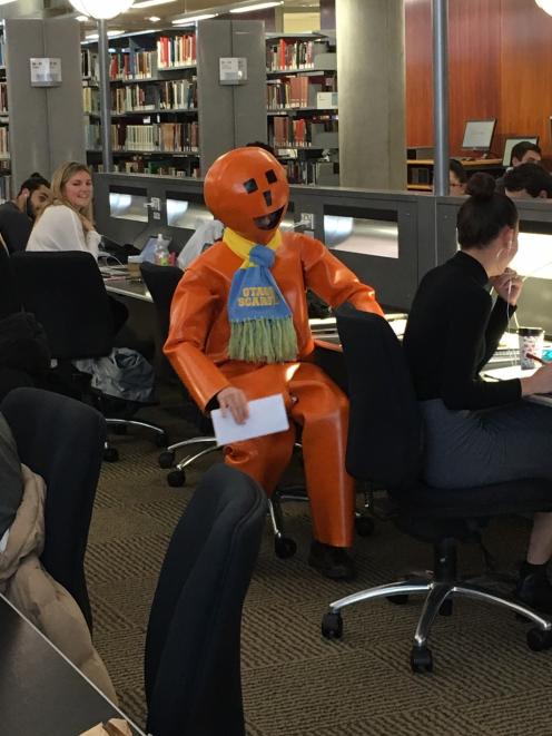 The Electoral Commission ‘‘orange guy’’ visits students at the University of Otago in a bid to encourage them to enrol to vote in the general election next month. PHOTO: SUPPLIED
