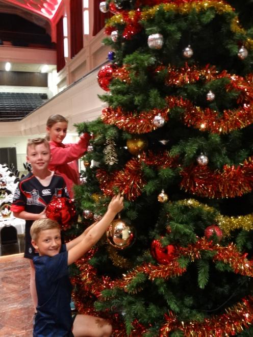 Among the volunteers are (from rear) Gabby Woodcock (12), Ollie Rongen (9) and Tim Woodcock (9), all of Dunedin, who helped to decorate the giant Christmas tree. PHOTO: BRENDA HARWOOD