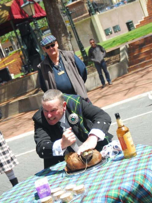 Marvellous carve ... Iain Seatter leads a Haggis Ceremony during the 2019 St Andrew's Day...