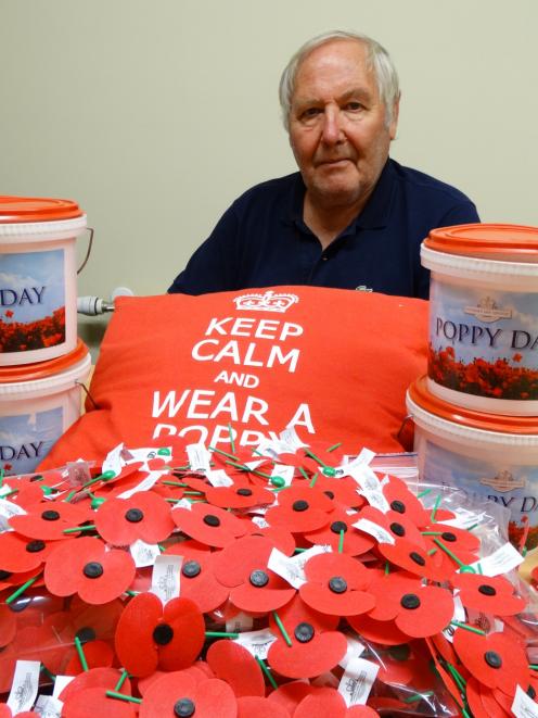 Dunedin RSA president Lox Kellas is surrounded by some of the 45,000 poppies being distributed...