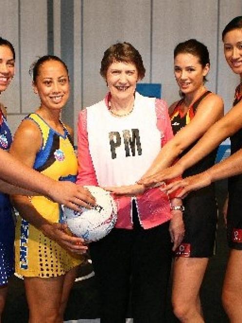 PM Helen Clark is surrounded by players (from left) Catherine Latu (Mystics), Grace Rasmussen ...