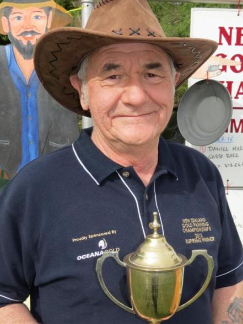 2012 New Zealand Gold Panning Champion Bill Lind, of Balclutha, with his trophy after the...