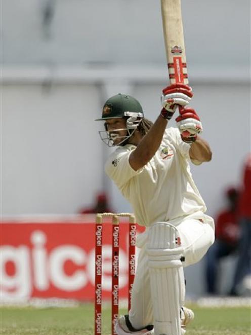 Australia's batsman Andrew Symonds watches his shot for four runs during second innings in the...