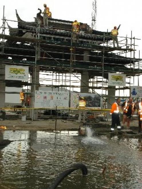 Construction work continues at the Dunedin Chinese Garden (at rear) while efforts are made to...