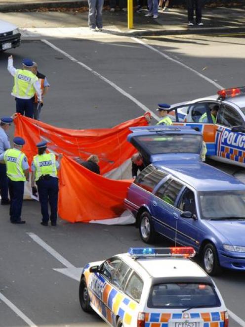 Police erect shields around the body of a 64-year-old Dunedin woman who died after an accident...