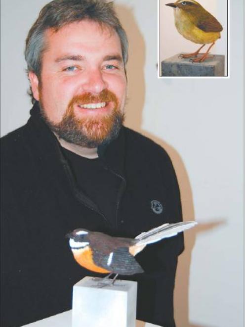 Luke Anthony stands alongside a fantail in his exhibition at Hullabaloo Art Space in Cromwell....