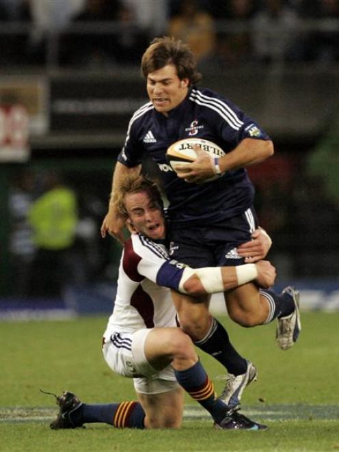 Stormers replacement Schalk Brits is tackled by Highlanders halfback Jimmy Cowan during their...