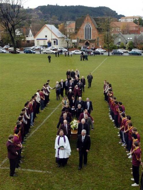 Rev Tim Hurd (left) and funeral director Robert Campbell lead pallbearers carrying Jack Welsh's...