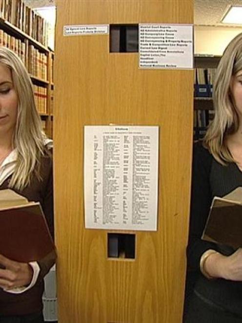 Identical twins Alexandra (left) and Sara Isherwood (23), who will practise law with different...