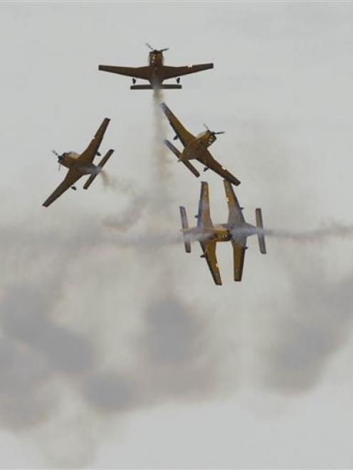 Members of the RNZAF Red Checkers aerobatic team perform during this year's Warbirds Over Wanaka...