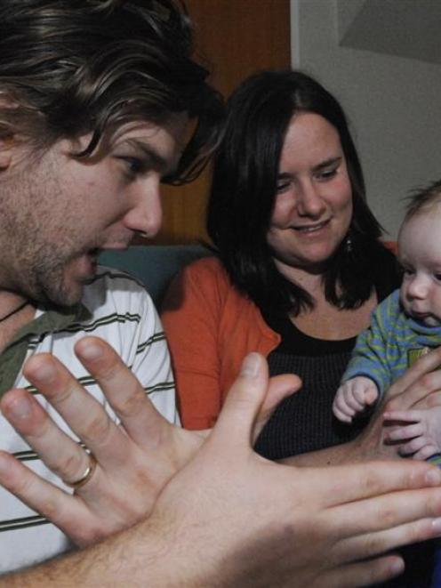 Michael May signs the word butterfly to son Luca and wife Nirvana. Photo by Linda Robertson.