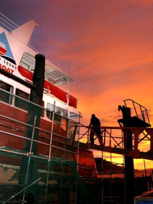 Tradesmen board the Fiordland tourism vessel Lady of the Sounds at the Kitchener St slipway...