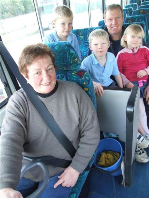 Graeme, Matthew (8), Caleb (7) and Ella (4) Taylor line up for one of Indy Gard's last bus runs....