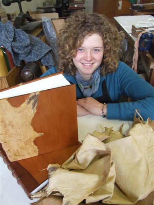 Jenny Lacey shows off the book she created using possum skin and totara wood. Photo by Sally Rae.