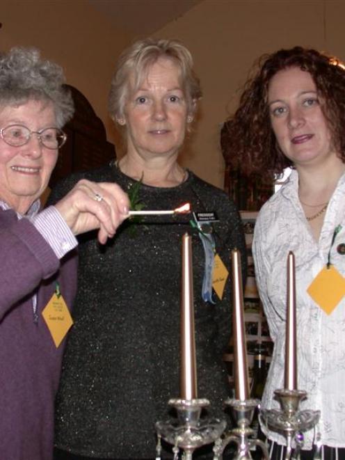 Foundation member of the Glenavy Women's Institute Jessie Allnutt (left) lights a candle to the...