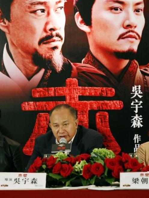 Hong Kong director John Woo, centre, speaks about his new movie 'Red Cliff' with Taiwanese...