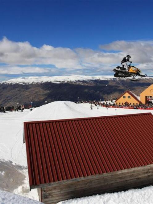 American Paul Thacker jumps a shed on his snowmobile at last year's big air competition at the...