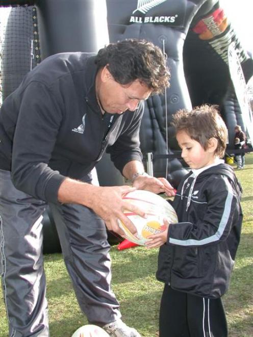 Leon Searle (4) of Oamaru, gets advice on passing from All Blacks great Buck Shelford at the All...