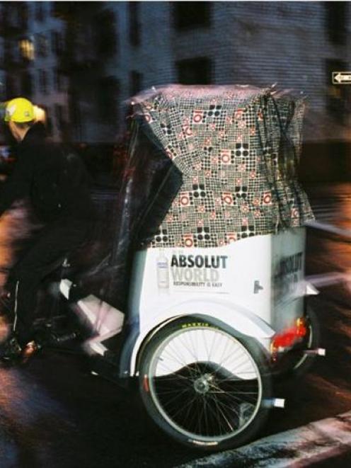 A Manhattan Rickshaw bicyclist steers through the city's mean streets. Photo from Main Street...