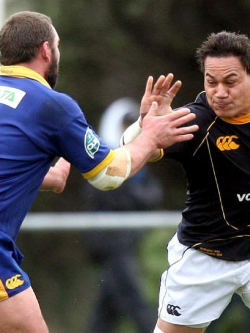 Wellington flanker Chris Masoe attempts to fend off Otago prop  Jed Vercoe yesterday. Photo by...