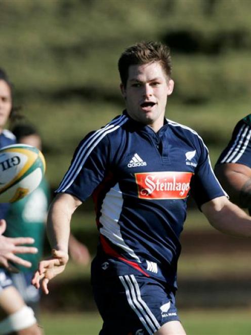 All Black Richie McCaw passes the ball during New Zealand All Blacks rugby training at Rugby...