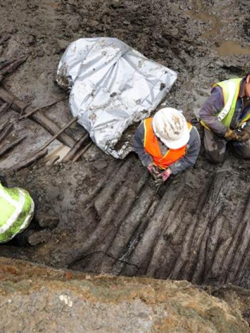 Peter Petchey (third from left) and fellow archaeologists work at the Dunedin City Council's Wall...