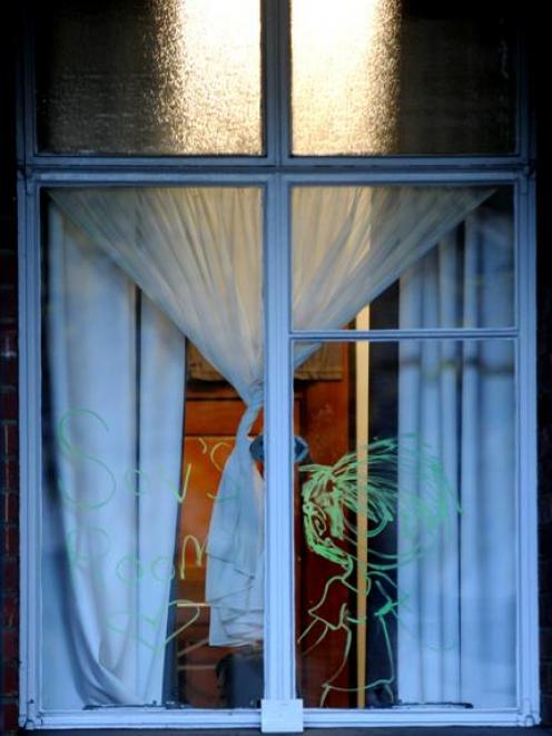 A ghostly apparition appears in a window of Cumberland Hall yesterday. Photo by Craig Baxter.