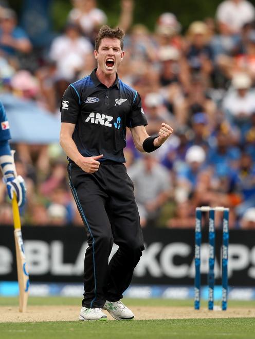 Adam Milne of New Zealand celebrates the wicket of Dimuth Karunaratne of Sri Lanka. Photo by...