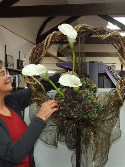 Balclutha Floral Art Club president Allison Dempster puts  the finishing touches to a display at...