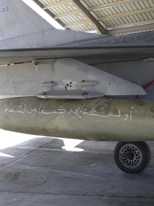 bomb with Koranic verses is pictured on a Royal Jordanian Air Force plane at an air base before...