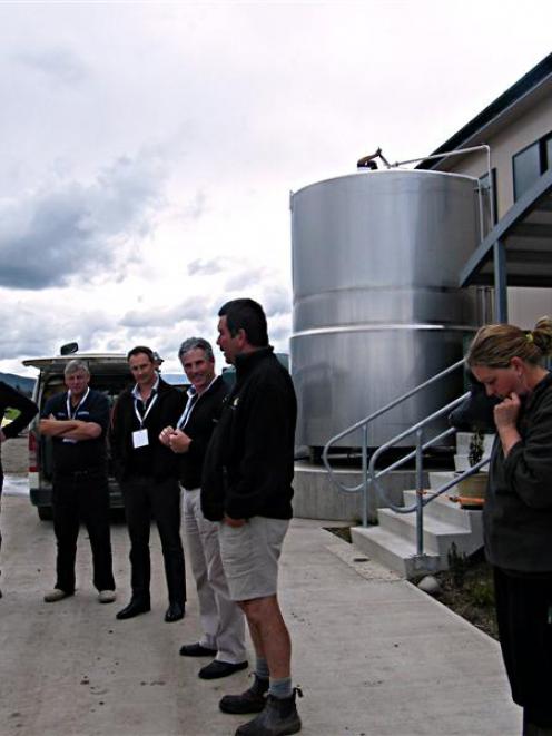 Bryan Beeston speaks to North Island farmers during the technology tour. His daughter Frances is...