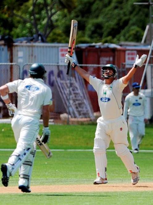 Central Districts batsman Mathew Sinclair runs through to complete his century during his team's...