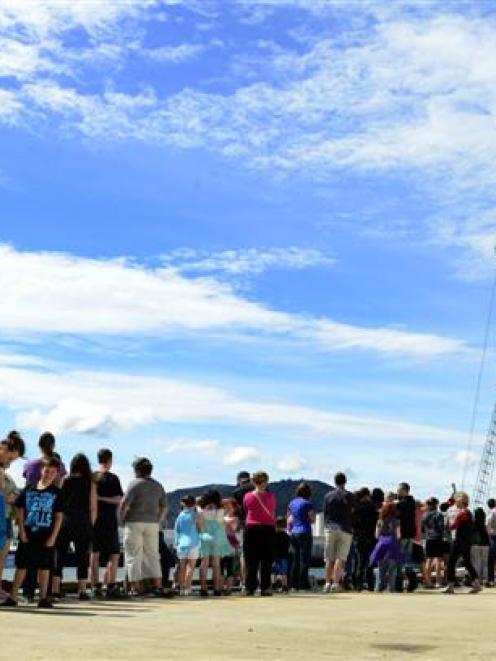 Children and adults queue at the Birch St wharf to tour  Spirit of New Zealand in Dunedin on...