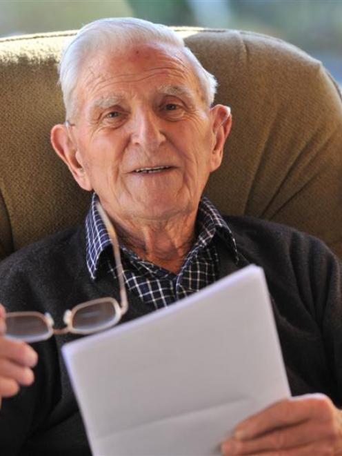 Eric Lundquist, at his home in Brooklands Village, Mosgiel, reads through letters received from...