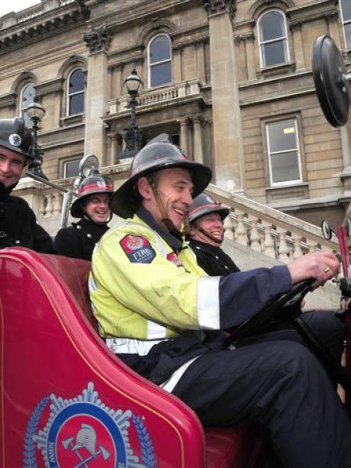 Fire Engine Restoration Society members (front seat, from left) Keith Ferris, Paul Clements, ...