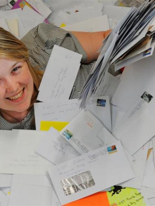 <i>Otago Daily Times</i> marketing co-ordinator Jess Peck at work yesterday with some of the 15...