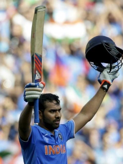 India's Rohit Sharma celebrates reaching his century against Bangladesh in Melbourne. REUTERS...