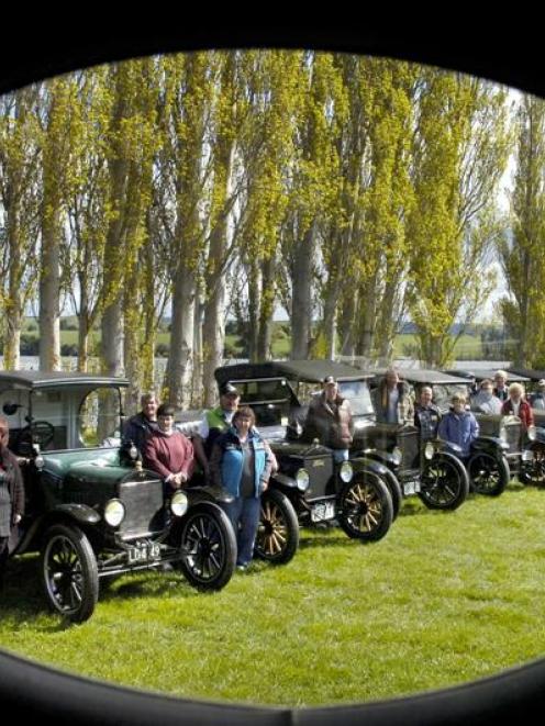 Members of the Model T Ford Club of New Zealand line up for a team photograph - through the...