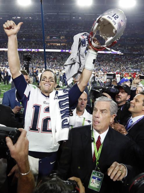 New England Patriots quarterback Tom Brady (12) celebrates after beating the Seattle Seahawks in...
