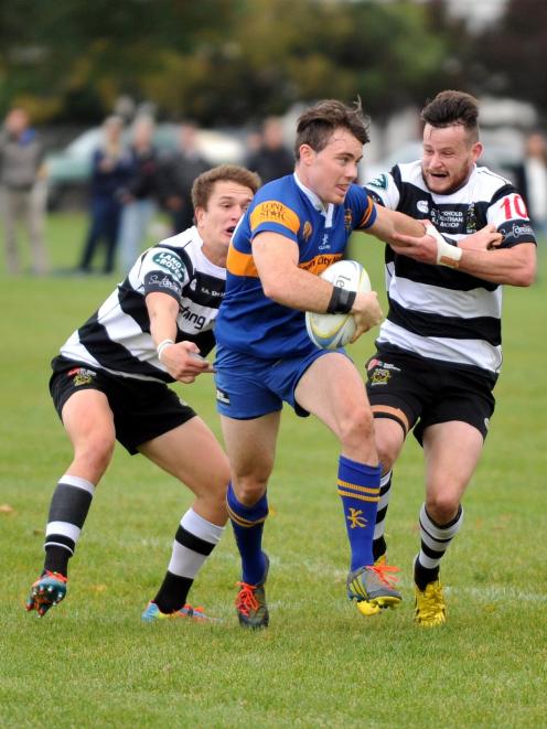 Taieri first five-eighth Josh Casey is tackled by Southern counterpart Bryce Hosie (right)  with...