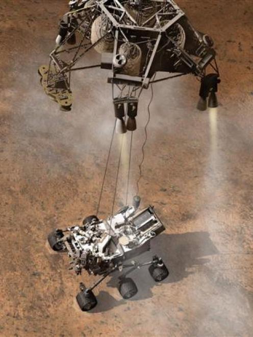 This artist's concept depicts the moment  when Nasa's Curiosity rover landed on Mars. Photo by...