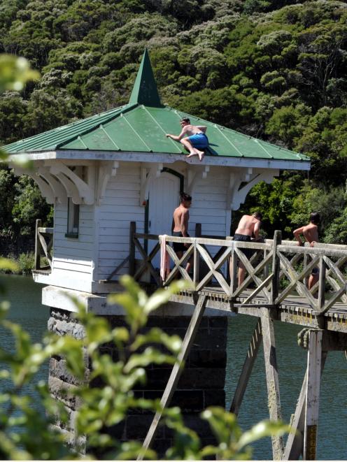 A 13-year-old boy climbs on the roof of the valve tower at Ross Creek Reservoir yesterday. Photo...