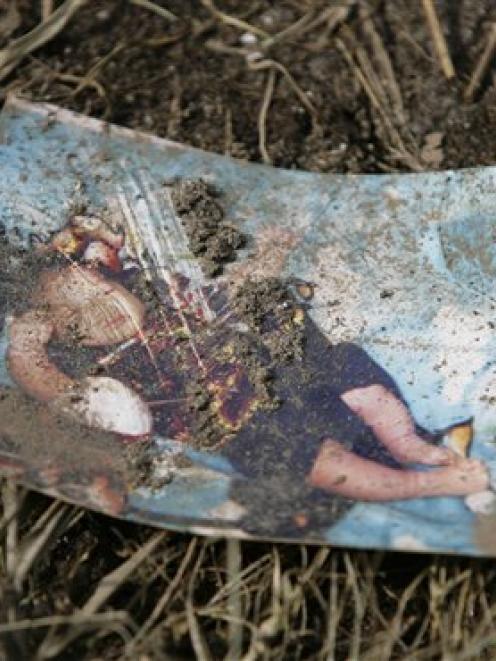 A baby picture lies on the ground covered in mud Wednesday September 30, 2009 -- one of the...